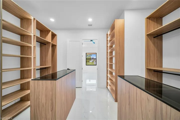Walk in closet with light tile patterned floors