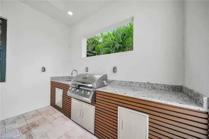 Kitchen featuring light stone counters and light tile patterned floors