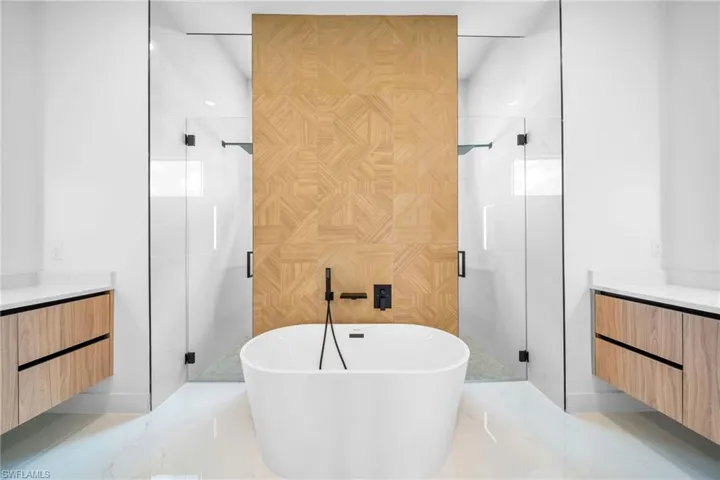 Bathroom with tile patterned flooring, plus walk in shower, and vanity