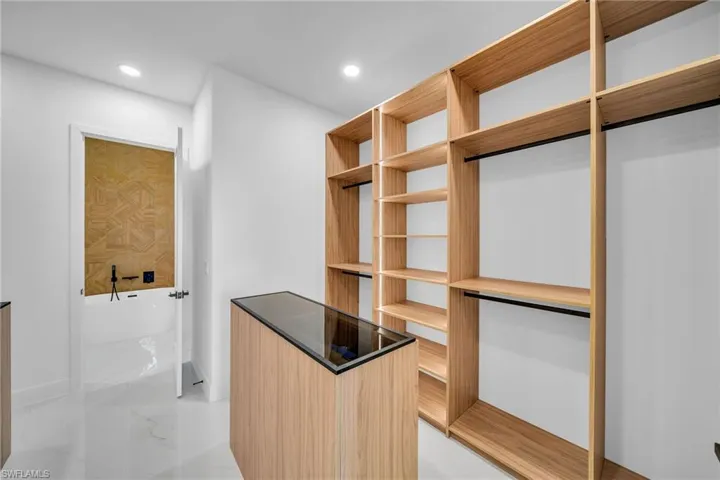 Spacious closet with light tile patterned flooring
