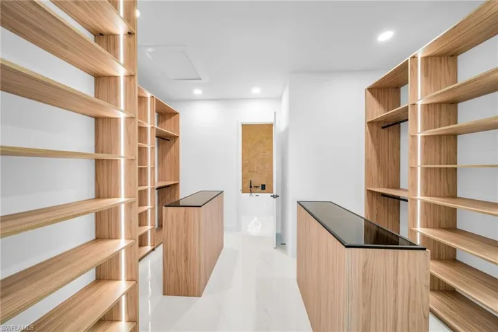Walk in closet with light tile patterned floors