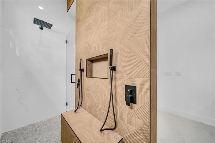 Details with tile patterned flooring and walk in shower
