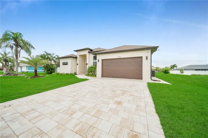 Prairie-style house featuring a garage and a front yard