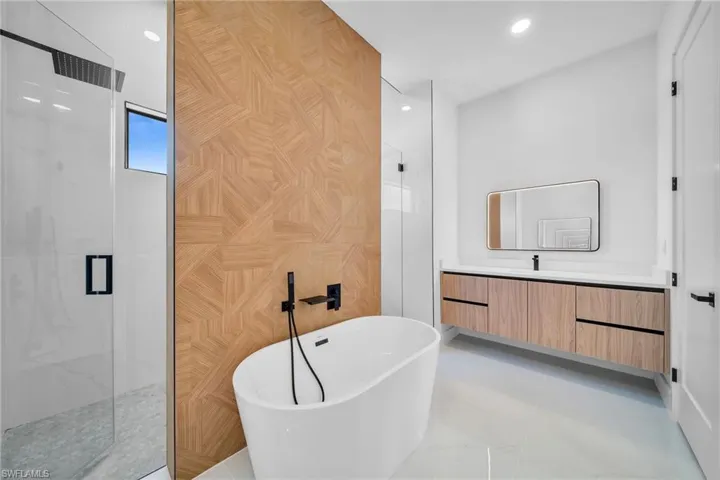 Bathroom with vanity, tile patterned flooring, and separate shower and tub