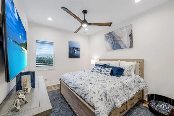 Bedroom featuring dark hardwood / wood-style flooring and ceiling fan