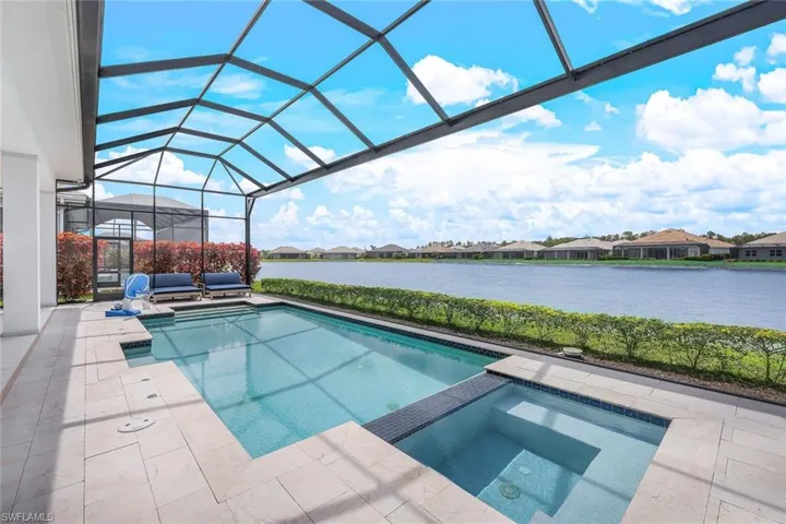 View of pool featuring a lanai, an in ground hot tub, and a patio area