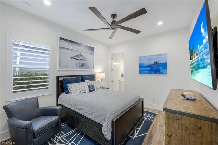 Bedroom featuring dark hardwood / wood-style floors and ceiling fan
