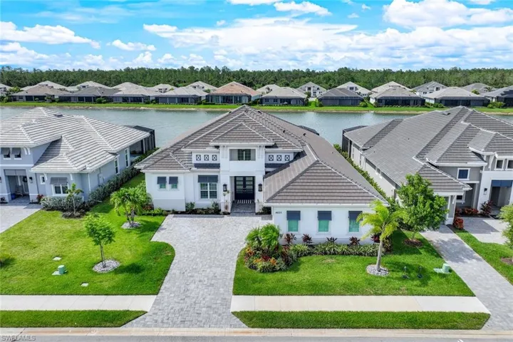 View of front facade featuring a front yard and a water view