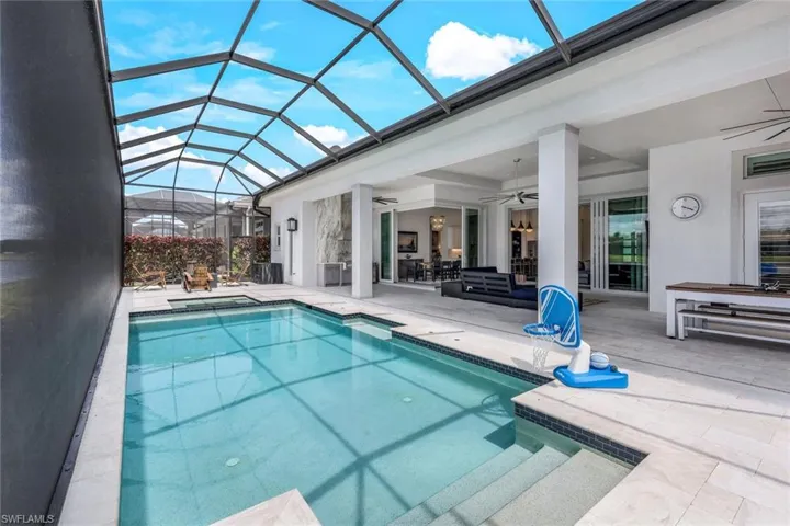 View of pool featuring a patio, a lanai, and ceiling fan