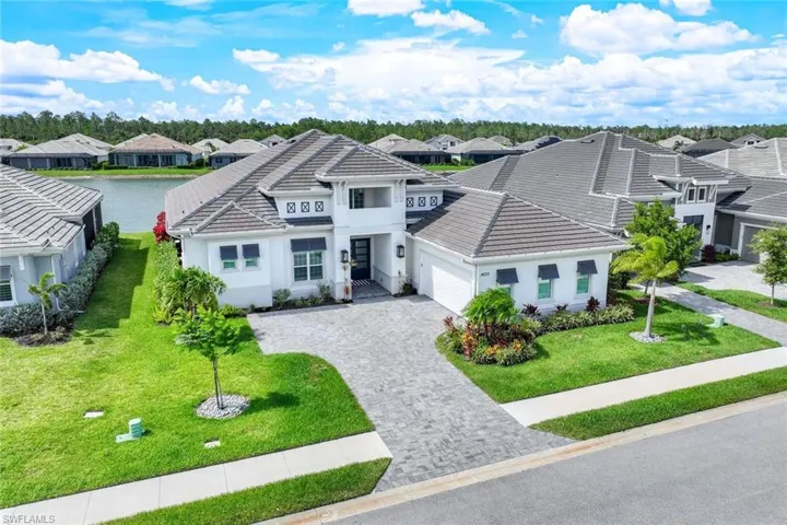 View of front of house with a garage and a front lawn