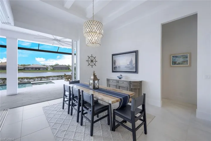 Tiled dining room with beamed ceiling and a notable chandelier