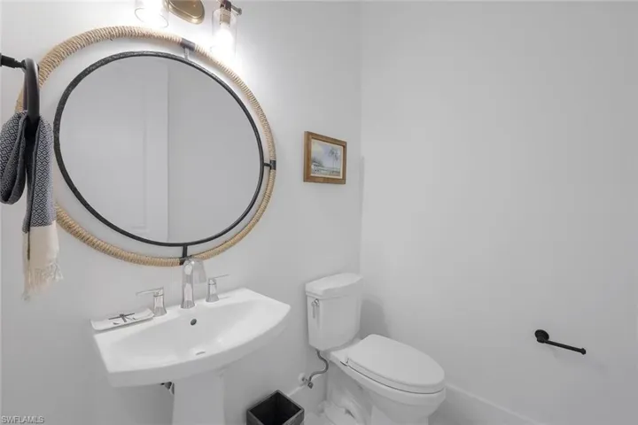 Bathroom featuring tile floors, sink, and toilet