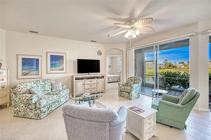 Living room featuring ceiling fan and light tile patterned floors