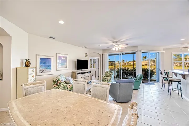 Tiled dining area with a healthy amount of sunlight and ceiling fan