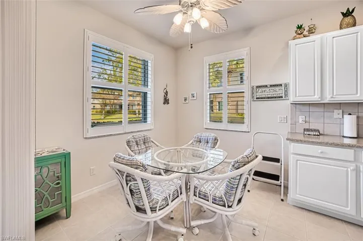 Dining area featuring light tile patterned floors and ceiling fan