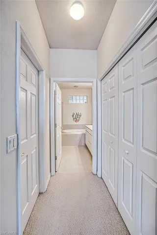 Hall with light tile patterned flooring