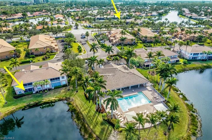 Birds eye view of property with a water view