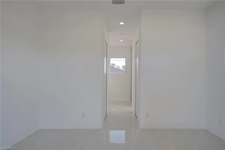 Unfurnished room with recessed lighting and baseboards