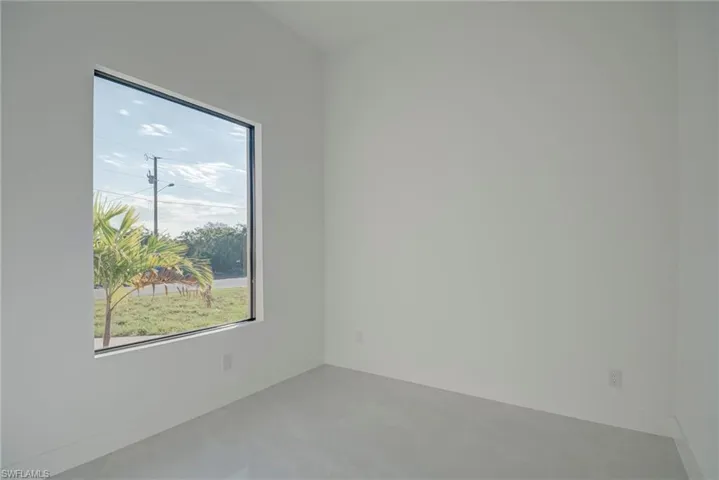 Empty room featuring baseboards and finished concrete floors