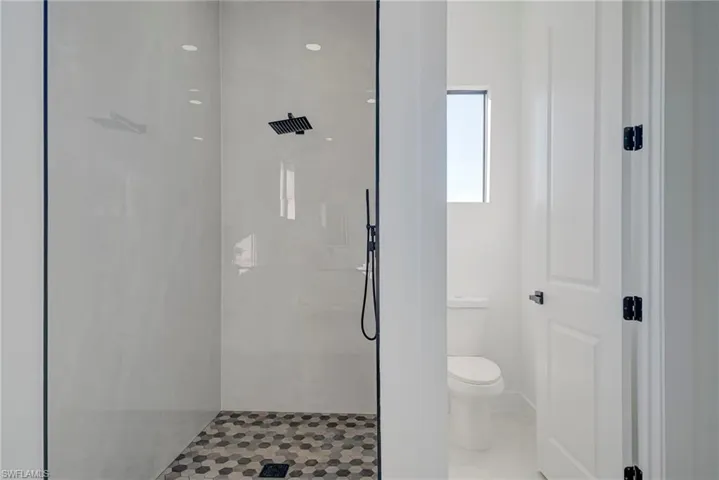 Full bathroom with a walk in shower and tile patterned flooring