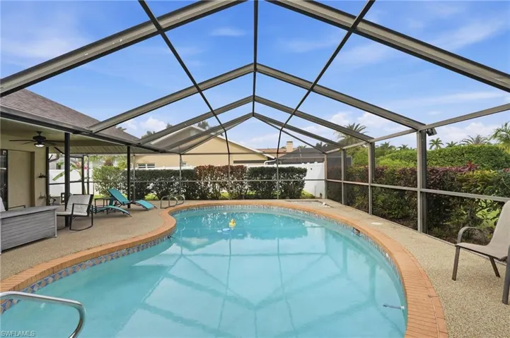 View of swimming pool featuring a sunroom, a lanai, and a patio area