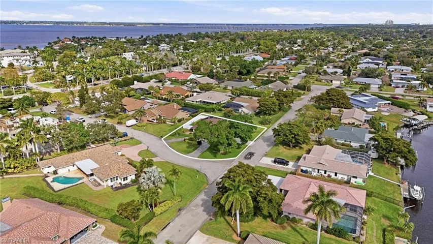 Aerial view of property's location with nearby suburban area and a nearby body of water