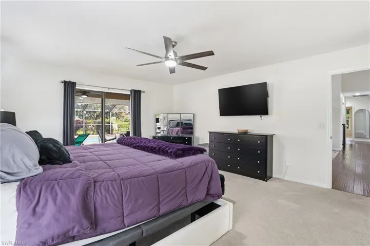 Bedroom featuring access to exterior, carpet, and ceiling fan