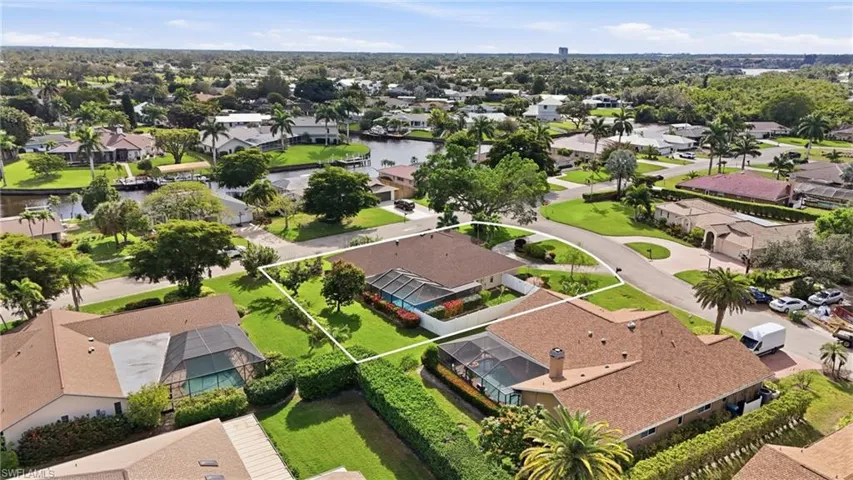 Aerial perspective of suburban area with a large body of water