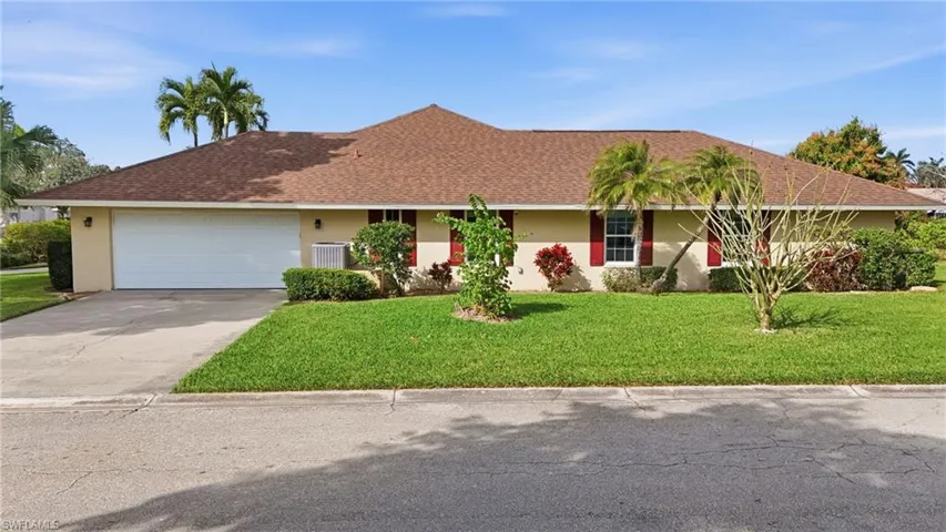 Single story home with a garage, stucco siding, and concrete driveway