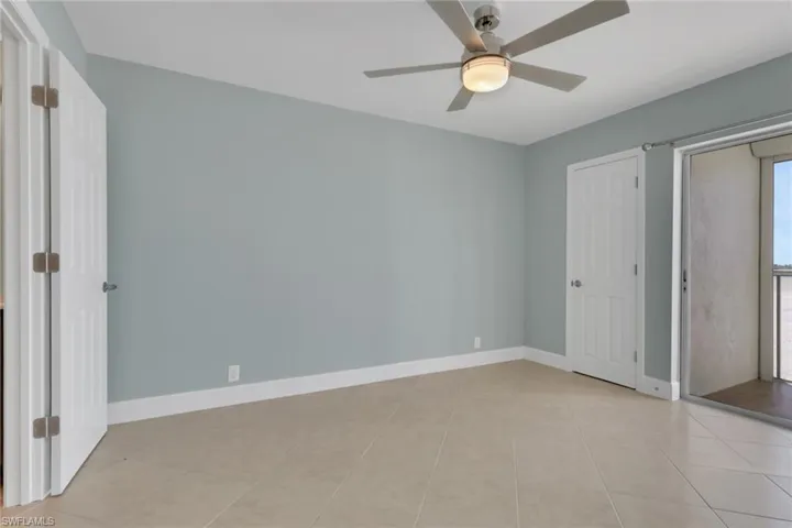 Unfurnished bedroom with a ceiling fan and access to exterior