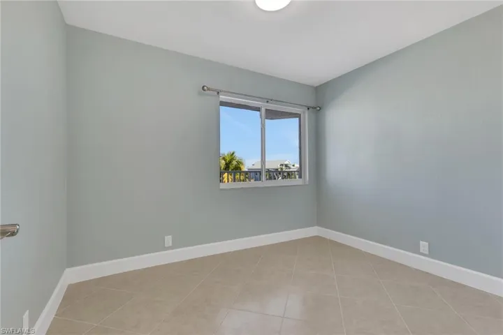 Spare room with baseboards and light tile patterned floors