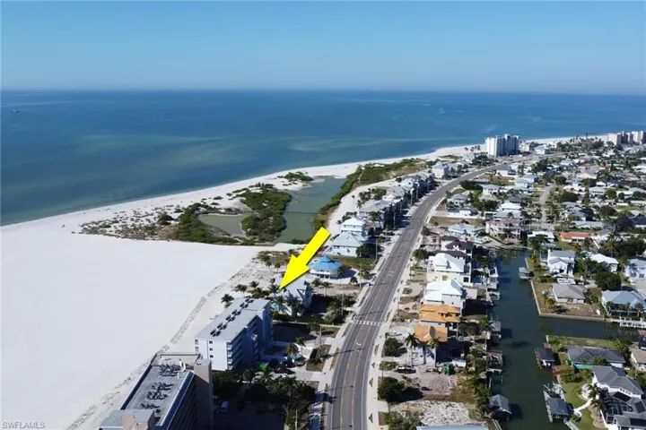 Aerial overview of property's location featuring a nearby body of water and nearby suburban area