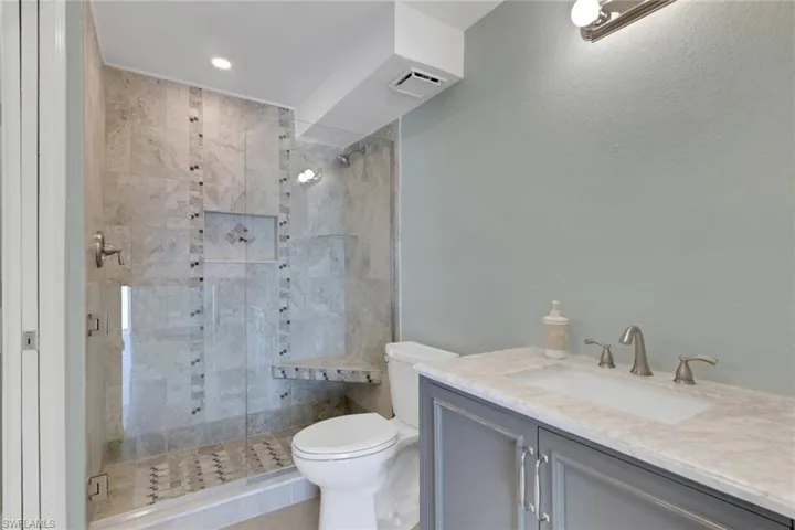 Bathroom with vanity and a shower stall