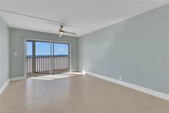 Spare room featuring ceiling fan and light tile patterned floors