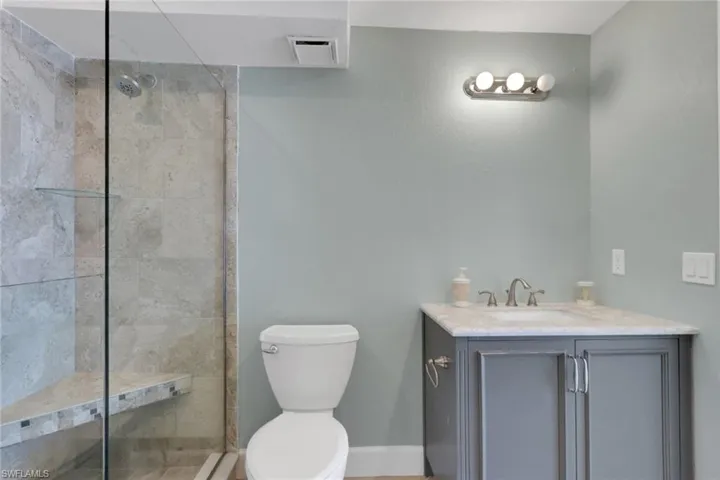 Bathroom with vanity and a walk in shower
