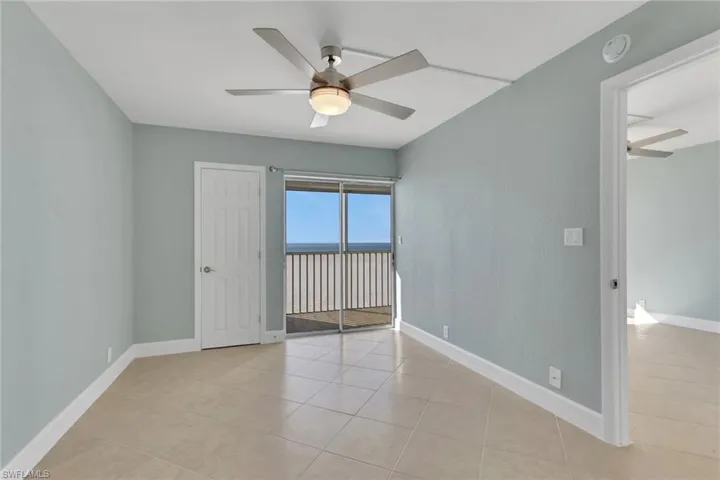 Unfurnished room featuring a ceiling fan and light tile patterned flooring