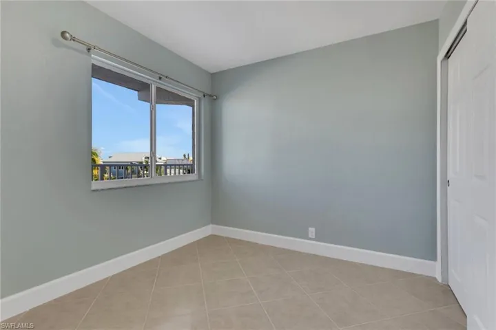 Unfurnished room featuring baseboards and light tile patterned floors
