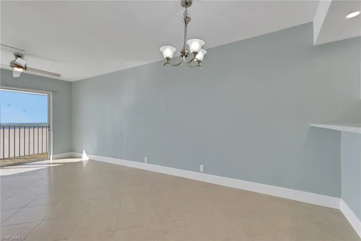 Spare room featuring a chandelier and light tile patterned floors