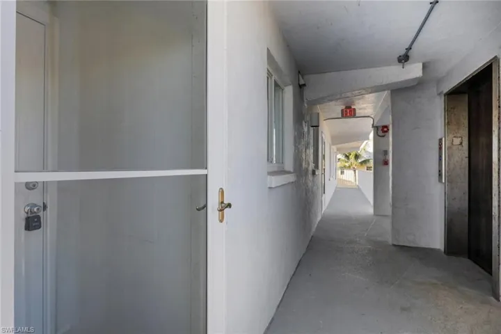Hall with elevator and concrete flooring