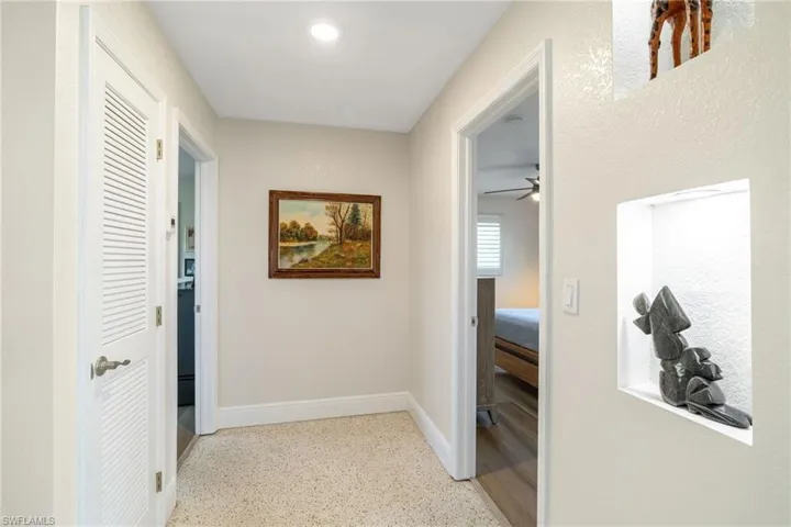 beautiful lit hallway entering bath and bedrooms