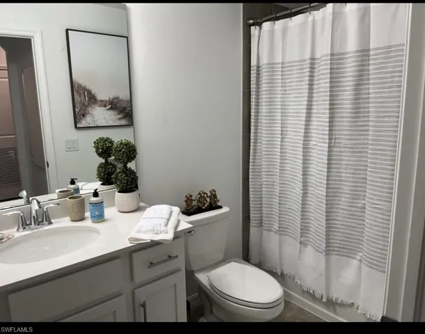 Bathroom with vanity and shower / bath combination with curtain