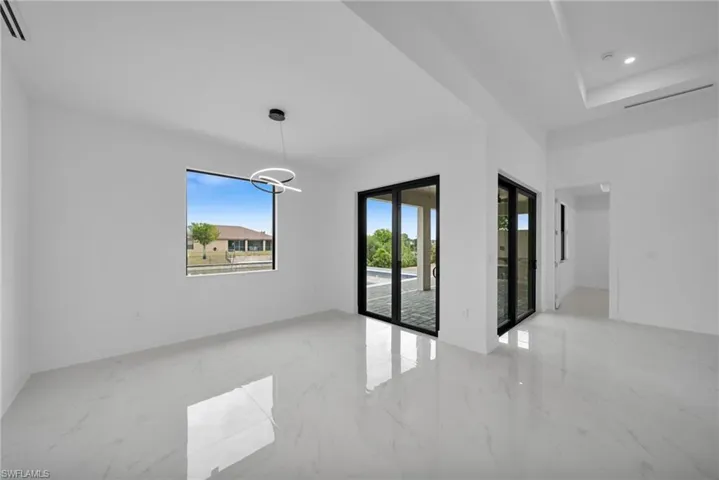 Spare room with light marble finish floors