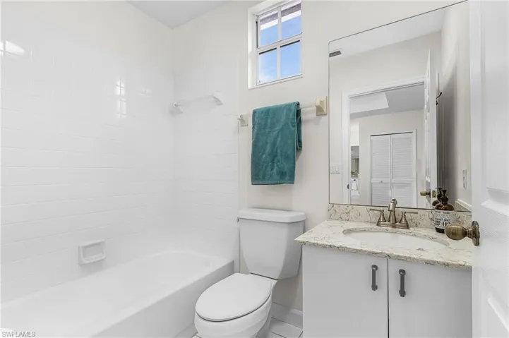 Ensuite Full bath in Bedroom #3 or Den with  shower combination, vanity, and tile flooring