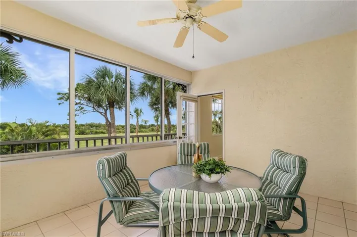 Sunroom / Lanai with views of the Golf Course.  Entrance to Primary Bedroom
