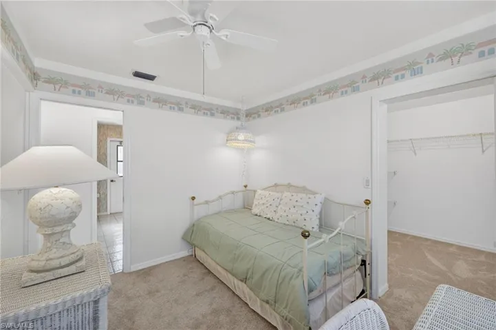 Bedroom featuring carpet flooring, a spacious closet, a closet, and a ceiling fan