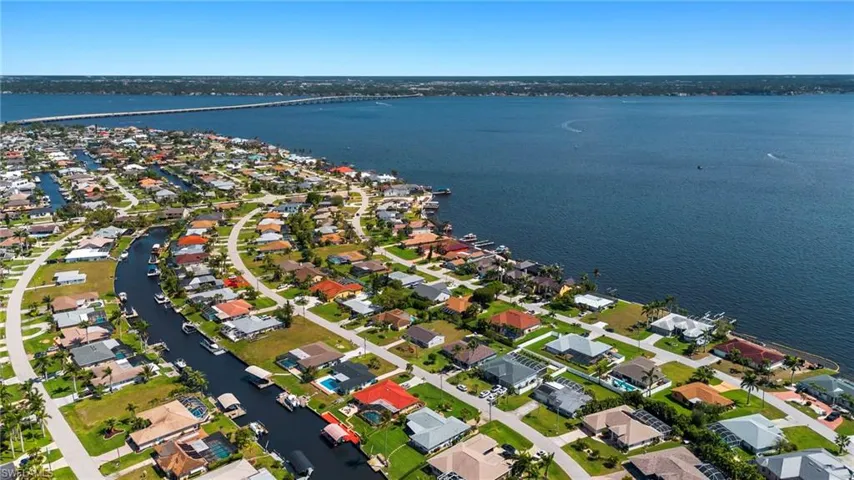 Aerial overview of property's location featuring a large body of water and nearby suburban area