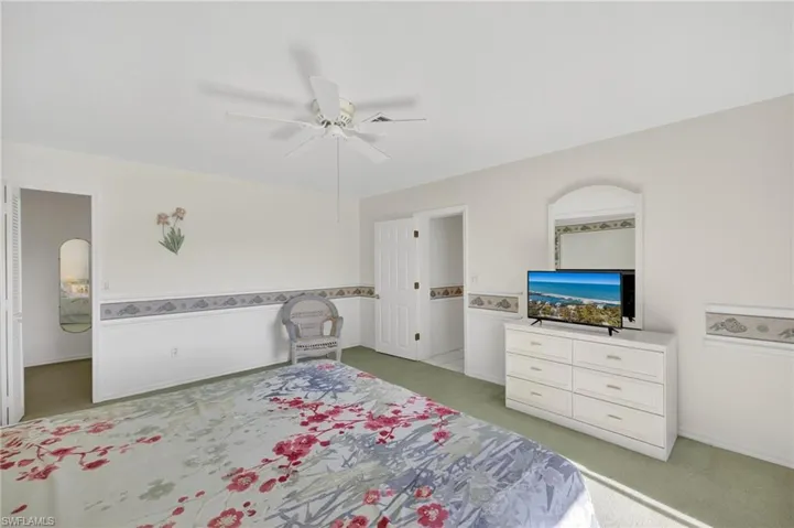 Bedroom featuring light carpet and ceiling fan