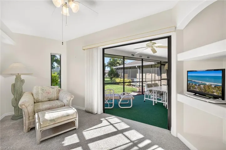 Living area with ceiling fan and carpet flooring