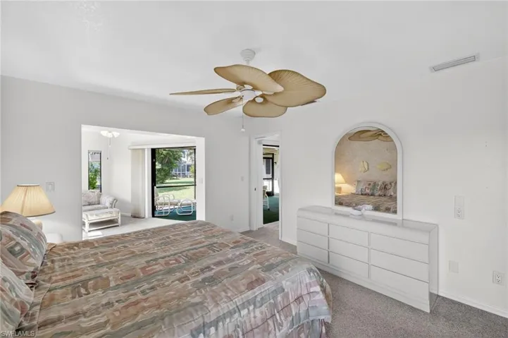 Carpeted bedroom featuring a ceiling fan