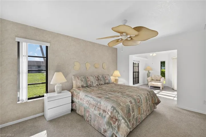 Carpeted bedroom featuring baseboards and a ceiling fan